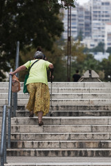 Old woman walking up the stairs