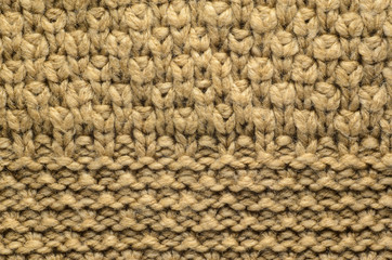 Beige Texture of a Knitted Sweater with Two Types of Knitting. Knit texture as background.