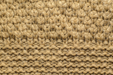 Beige Texture of a Knitted Sweater with Two Types of Knitting. Knit texture as background.