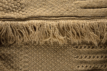 Knit Cloth with Fringe Background. Beige Knit Sweater Blank Backdrop