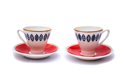 Two red coffee cups with saucers, isolate