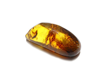 Unique transparent amber on a white background. A beautiful natural mineral for jewelry. Fossil Resin. A sunstone. A piece of amber stone with inclusions and patterns inside.
