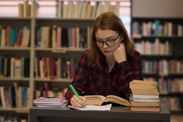 Young woman writing on paper