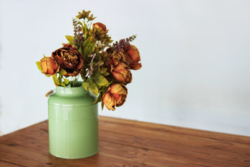 Bouquet of dried flowers in vase on table and light background. A bouquet of dried flowers in a vase. Dry flowers