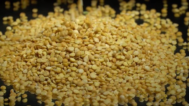 Dried peas pour into the pile, slow motion