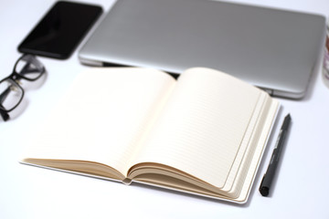 Notebook, pen and Laptop on White background
