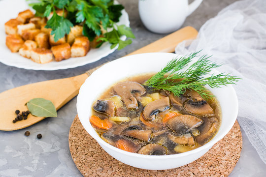 Homemade mushroom soup with champignons, fresh herbs and breadcrumbs