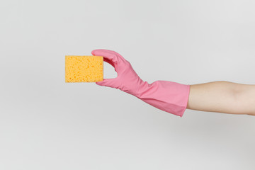 Close up of female hand in pink gloves horizontal holds yellow-orange sponge for cleaning and...