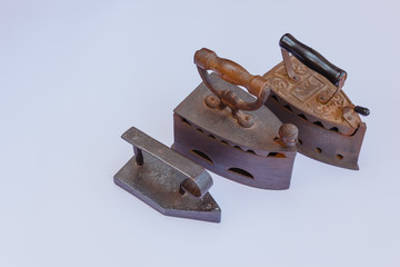 three vintage irons /three old irons  made of cast-iron   on a shirt