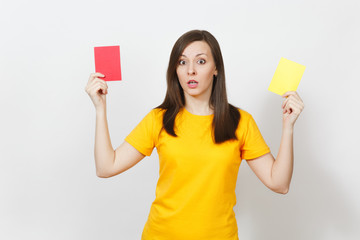 European serious severe young woman, football referee hold choose yellow and red soccer cards,...