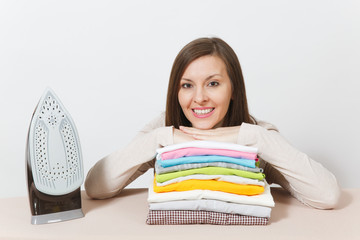 Close up fun tired shocked housewife in light clothes ironing checkered shirt, clothing on ironing board with iron. Woman isolated on white background. Housekeeping concept. Copy space advertisement.