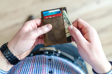 Man holding leather wallet