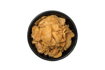 Top view of corn flake cereal in black ceramic bowl isolated on white background with clipping path