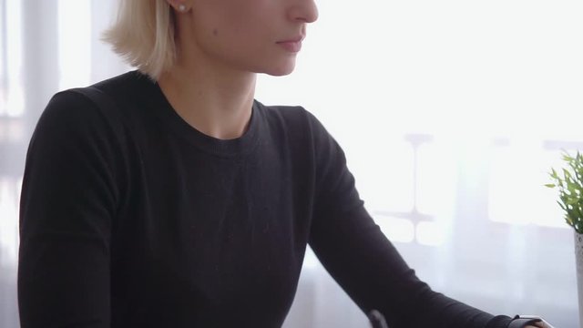 Female use a graphic tablet and stylus to work behind a modern computer screen. Young girl working distance