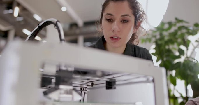 Female looking at 3D printer