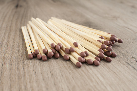 A pile of wooden safety long match sticks on wooden background