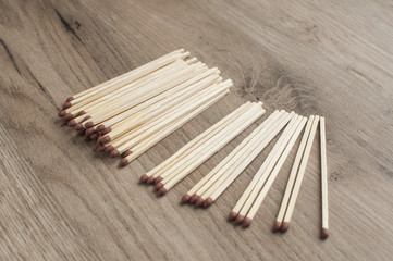 A pile of wooden safety long match sticks on wooden background