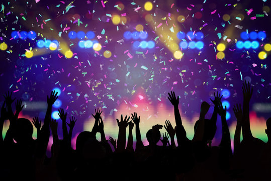 Abstract Party Background - Crowd People Enjoy Dancing and Show Hands Up in the Concert with Beautiful Lighting and Laser