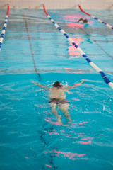 Fit swimmer on the pool. Breathing exercises in water