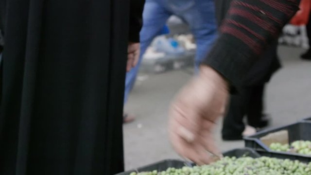 A seller dropping olives from his hand in Nabatieh, Lebanon. Slow motion