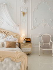 Interior of cozy classic white bedroom