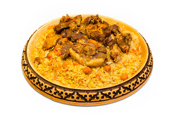 Kazakh meal plot. 
Kazakh national meal plov on a plate on white background. Wooden plate with kazakh national ornament