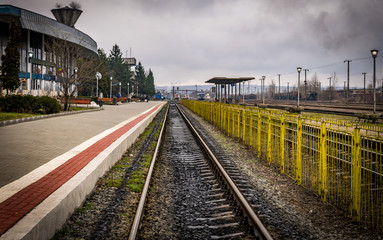 Fototapeta premium This is a train station with a yellow fence 