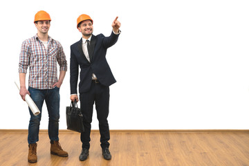 The two engineers gesture on the white wall background