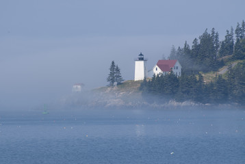 Foggy Island Lighthouse in Maine is Iluminated By the Sun Breaking Through the Fog © alwoodphoto