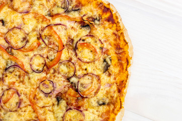 Fresh baked pizza on white wooden table. Top view. Copy space.