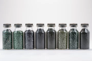 Fototapeten Various types of gunpowder in glass jars on a white background © J.C.Salvadores