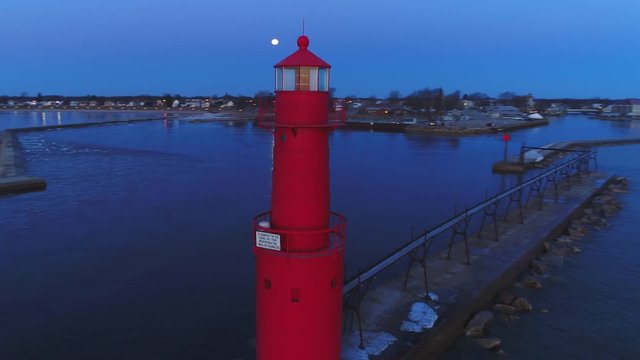 Amazing aerial 360 degree rotation of Iconic Lighthouse amid Lake Michigan dawn.
