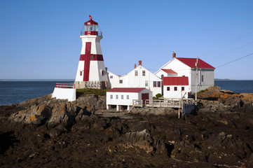 Fototapeta na wymiar Canadian Lighthouse with Painted Cross During Low Tide on Campobello Island