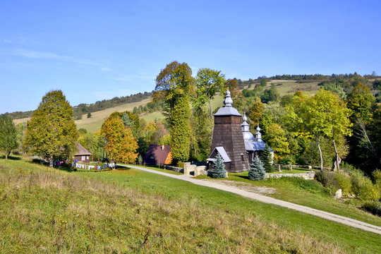 Autumn landscape in Low Beskid with wooden church in Chyrowa, Poland