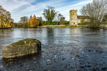 Frozen village pond with church