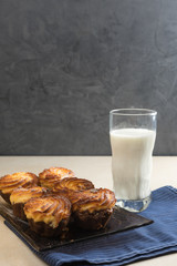 Chocolate cheesecake cupcakes and a glass of milk for Breakfast. Vertical. Copy spase