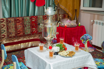 Novruz holiday background . Semeni on vintage plate decorated . Samovar and teapot . Samovar on a background of Novruz holiday . Tea in the tablecloth cups