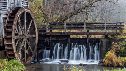 Flowing water over a damn with water wheel