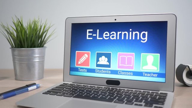 Elearning concept showing on a laptop computer screen sitting on a desk. Camera is slowly turning around the computer.
