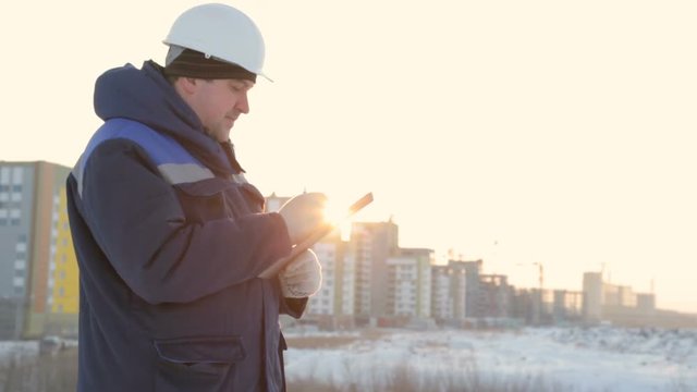 Foreman with tablet at major construction project