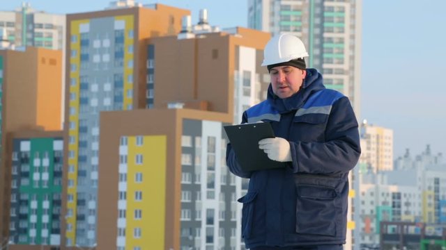 Foreman with tablet at major construction project