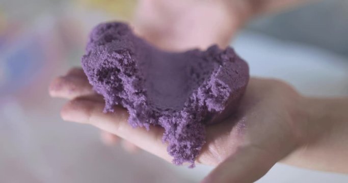 little girl plays with kinetic sand