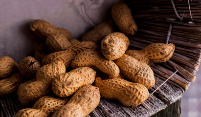 Peanuts in nutshell on a piece of wood