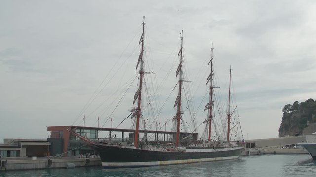 Ship with masts anchored in a port