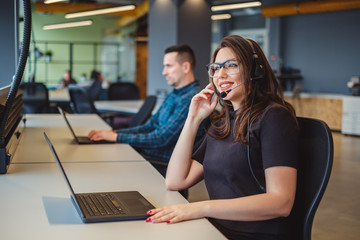 Female operator talking on the headset with client