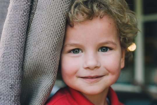 Portrait of a cute curly blond kid