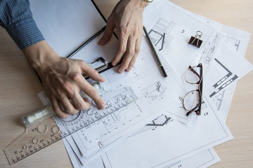 Architect's desktop. Plan of house. Architect workplace. Architect is working with drawings. Office work. Engineer calculates area of the room.