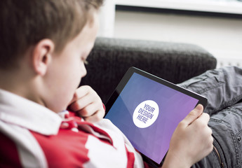 Young User Relaxing with Tablet Mockup