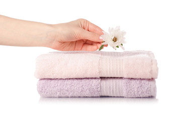 Fototapeta na wymiar A stack set of towels pink flower in hand