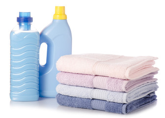 Obraz na płótnie Canvas A stack of towels softener conditioner liquid laundry detergent